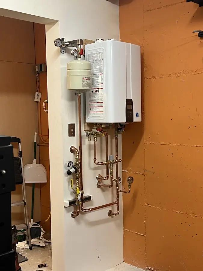Plumbing technician inspecting water heater connections in North Lebanon